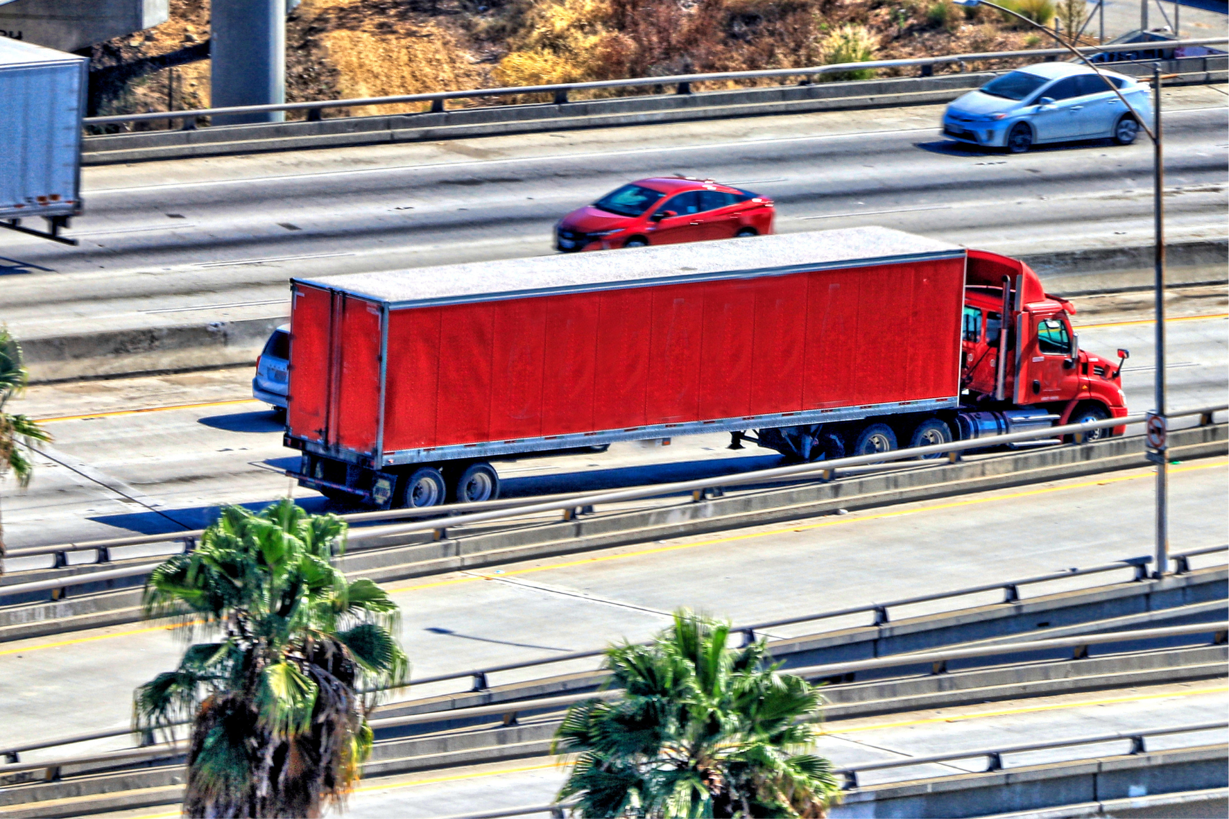 a red semi truck on a highway